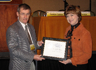 Mitch Whittle (left), Farm Loan Chief in Kentucky, accepts a certificate from Administrator Teresa Lasseter (right) to commemorate his completion of the Farm Loan Chief Mentoring Program. 