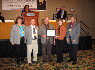 Wyoming Farm Loan Programs accepts a certificate of appreciation for maintaining a low direct loan delinquency rate and reducing the direct loan loss rate. (From left) Becky Gerlach, Farm Loan Specialist; Brian Harrell, Farm Loan Manager; David Gunderson, Farm Loan Chief; Teresa Lasseter, Administrator; Chuck Land, District Director. 