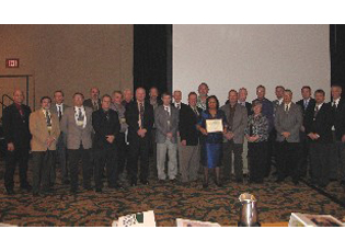 The 23 Farm Loan Chiefs whose states met all FLP goals in 2008 accept a commemorative certificate. 