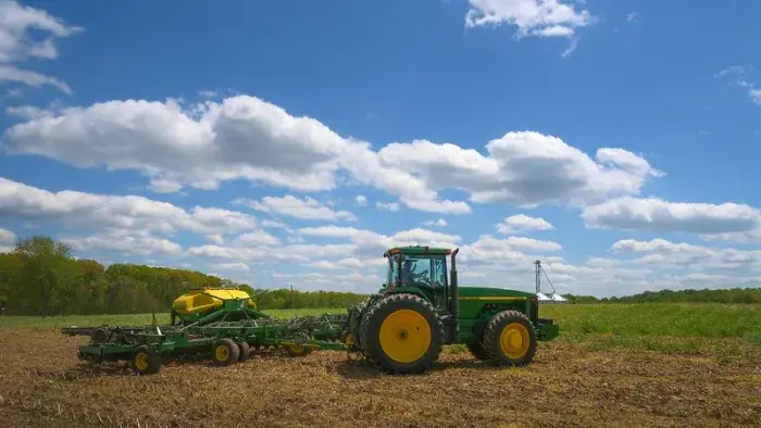 A farmer plants soybeans